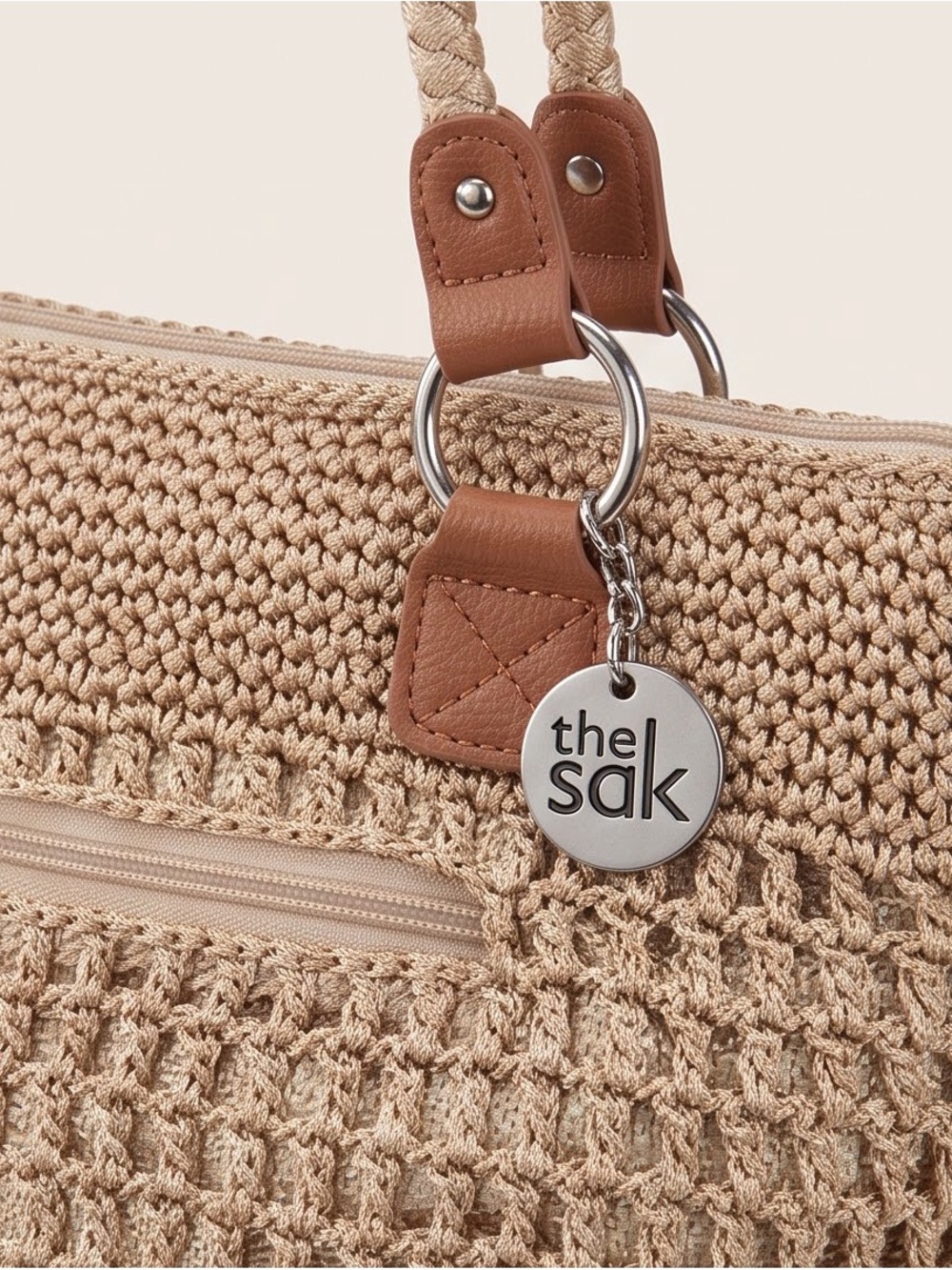 The Sak Beige Crochet Tote with Tan Trim and Silver Logo Charm